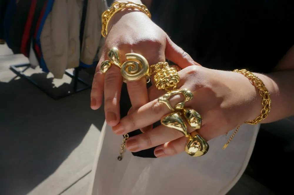 Manos con anillos y cadenas de oro hechos a medida